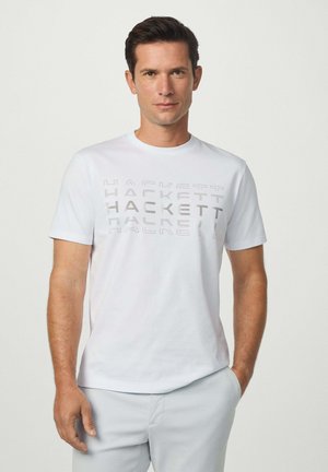 Weißes T-Shirt mit erhabenem grauen "HACKETT"-Schriftzug auf der Brust, kurzen Ärmeln und einem Rundhalsausschnitt. Aus glattem Baumwollstoff.