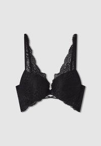 Maschera nera in pizzo con coppe imbottite, spalline regolabili e un design decorativo a incrocio al centro frontale. Un delicato bordo in pizzo accentua i contorni.