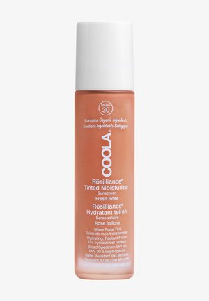 Tinted moisturizer in a clear plastic bottle with a white cap. Label features pink text. Contains SPF 30 and organic ingredients. 44 mL.