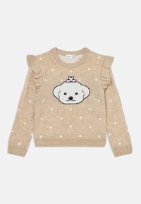 Beige strikkegenser med hvite prikker, volanger på ermene og et sentralt design av et hvitt bjørneansikt prydet med en rosa sløyfe.