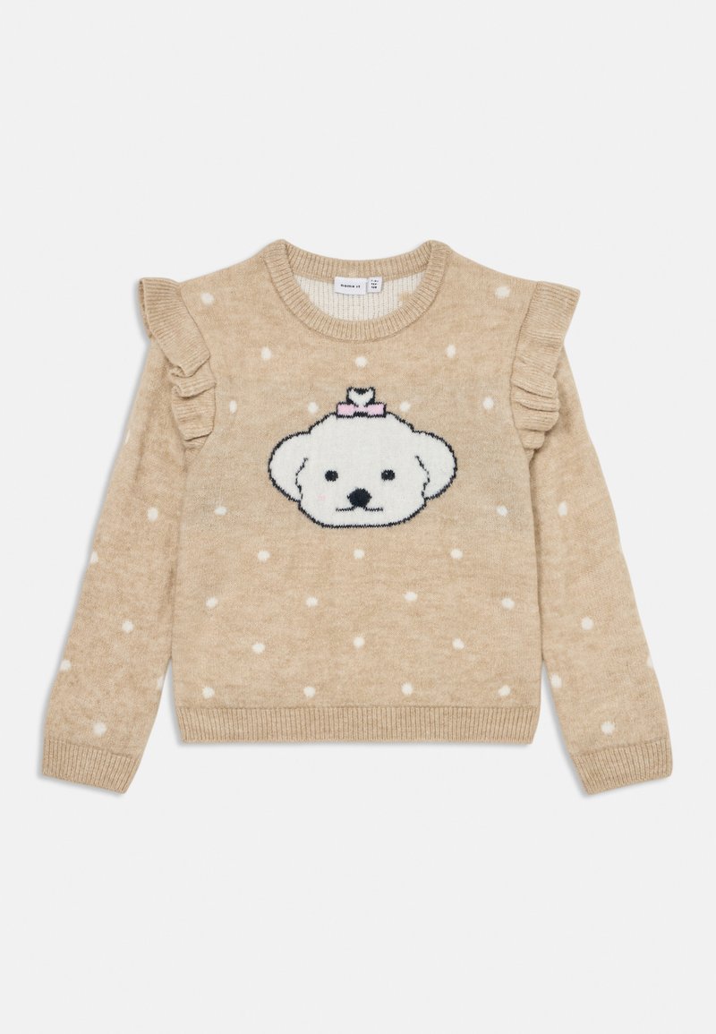 Beige strikkegenser med hvite prikker, volanger på ermene og et sentralt design av et hvitt bjørneansikt prydet med en rosa sløyfe.