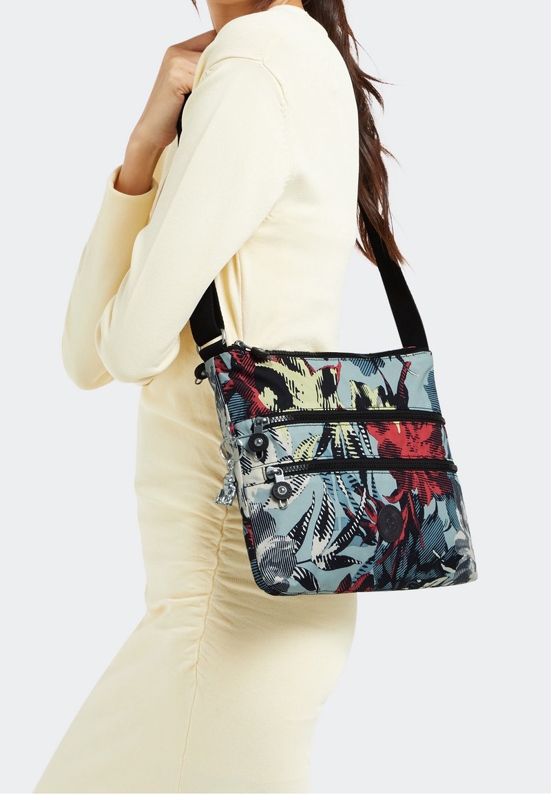 Colorful fabric crossbody bag featuring a floral pattern, three zippered compartments, and an adjustable black strap.