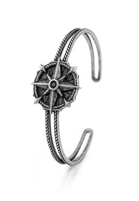 Silver-tone metal cuff bracelet featuring a compass design at the center with intricate detailing, braided texture, and open-ended shape.