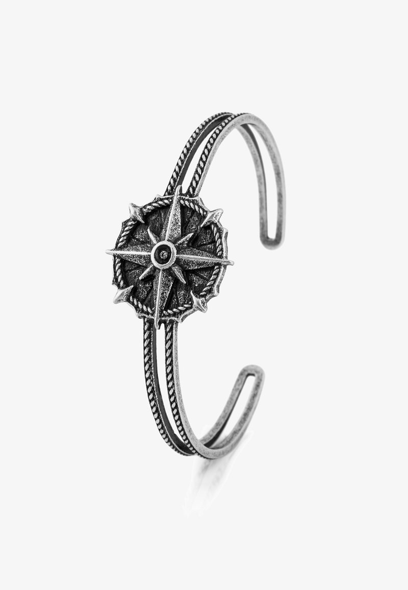 Silver-tone metal cuff bracelet featuring a compass design at the center with intricate detailing, braided texture, and open-ended shape.