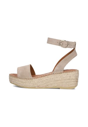 Beige platform sandal with ankle strap, buckle closure, open toe, and woven espadrille-style sole against a white background.