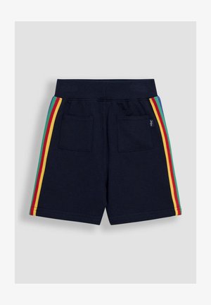 Tengerészkék pamut sort, puha tapintással. Két hátsó zsebe van, és többszínű oldalsávokkal rendelkezik piros, sárga, zöld és kék színekben.