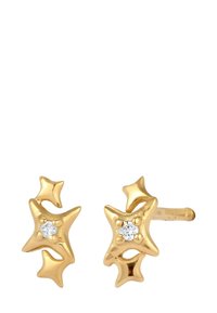 Goldene Ohrstecker in Sternform mit dreidimensionalen Details und kleinen zentralen Steinen. Glatte Textur mit glänzendem Finish.