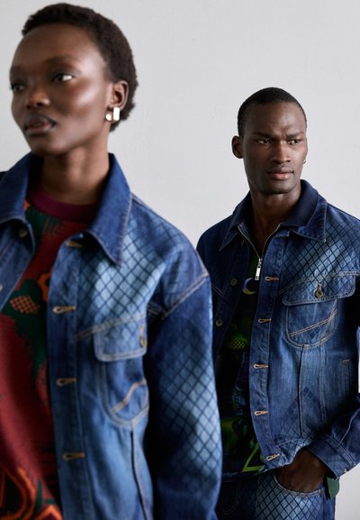Two models wear denim jackets featuring a quilted pattern in varying shades of blue. The jackets have classic styling with pocket details.