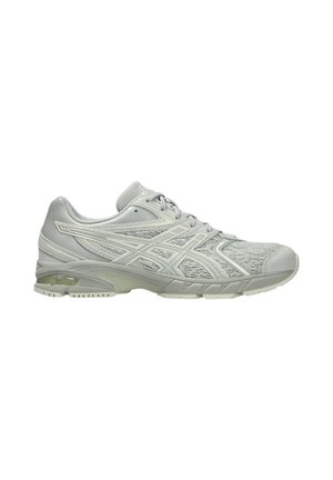 Light gray athletic sneaker with mesh upper, lace-up closure, cushioned sole, and branded side detailing shown from the outer side.