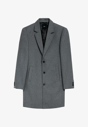Szary wełniany płaszcz z wyciętym kołnierzem, z przodu na trzy guziki, dwie boczne kieszenie i czarne akcenty guzikowe. Gładka podszewka wewnętrzna.