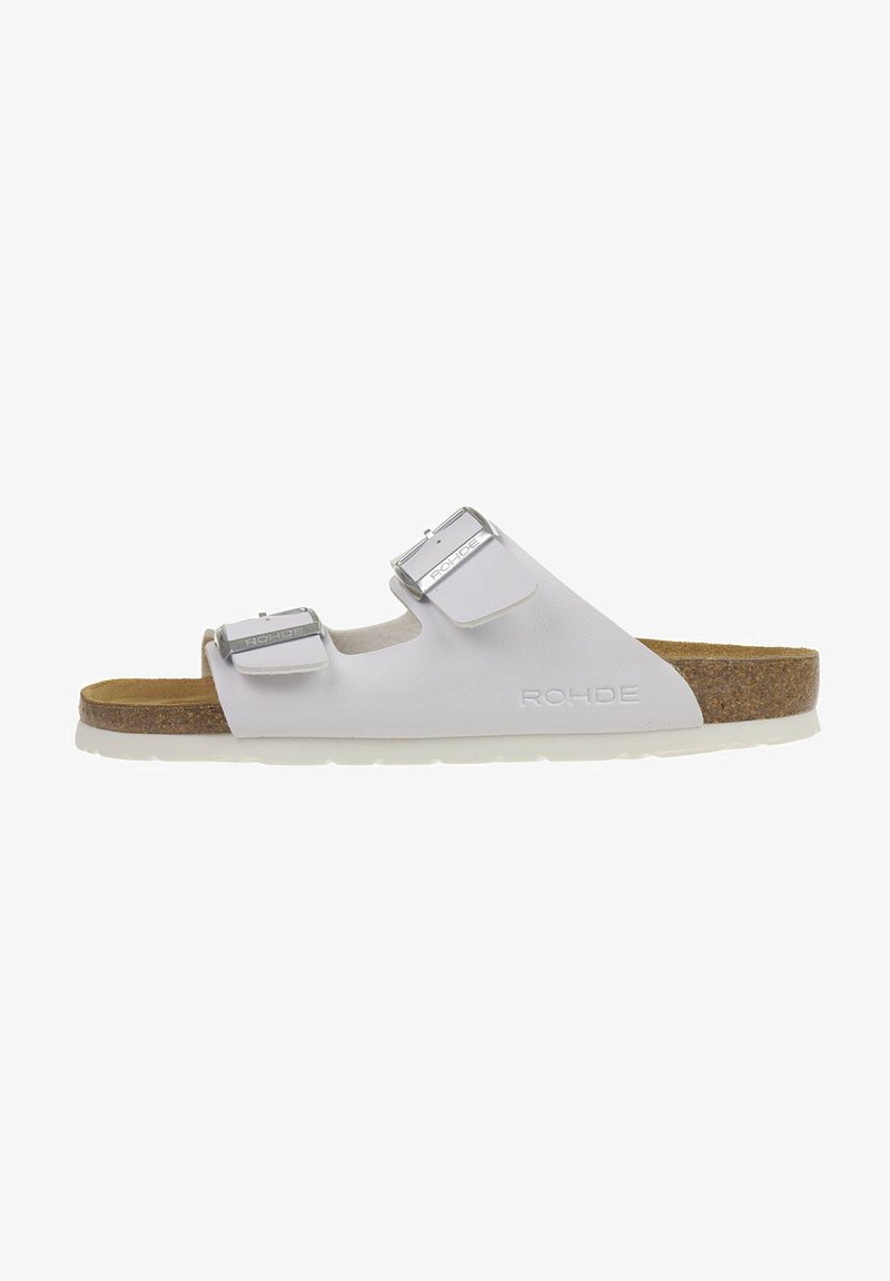 White slide sandal with two adjustable metallic buckles, cork footbed, and rubber outsole. Features embossed logo on the side.