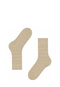 Calze beige a coste con un design testurizzato, dotate di tallone e punta rinforzati, realizzate in un materiale morbido ed elastico per garantire comfort.
