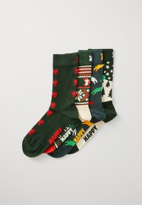Fünf Paare Socken in verschiedenen Farben, darunter Dunkelgrün, Beige und Marineblau, mit Mustern wie Schleifen, Tieren und festlichen Designs.