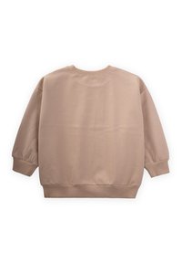 Sudadera beige de gran tamaño con mangas largas y abullonadas y puños acanalados. Tejido suave y escote redondo sin adornos ni estampados.