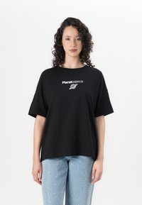 Black cotton oversized t-shirt featuring "Planet aspects" logo in white. Short sleeves, relaxed fit, with smooth texture.
