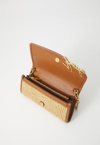 Brown leather and woven straw handbag featuring a gold snap closure, chain strap, and a zippered pocket inside. Open design showcases interior.