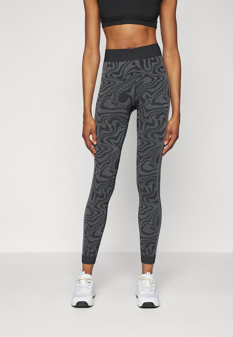 Black leggings with a textured, swirling pattern in shades of gray; high waistband and ankle-length with a snug fit.