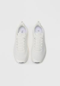 Pair of clean white athletic sneakers with laces, viewed from above on a white background.