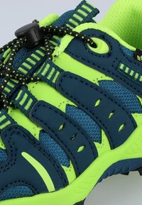Blue and neon green athletic shoe with mesh fabric, rubber sole, elastic laces, and reinforced toe cap. Features stripes and ventilation holes.