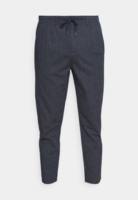 Navy blue, raidalliset jogger-housut, joissa on joustava vyötärö ja säädettävä nyöri. Kapean mallin lisäksi ne ovat pehmeät ja niissä on sivutaskut.