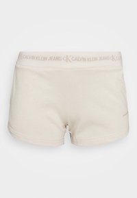 Beige bavlněné šortky s širokým elastickým pasem a logem "CALVIN KLEIN JEANS". Hladká textura a minimalistický design.