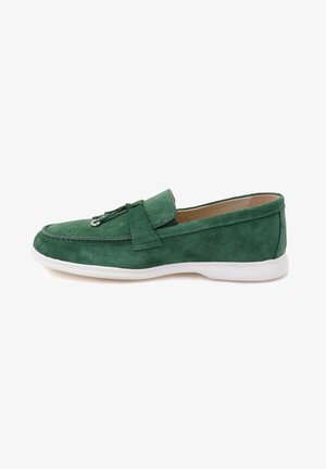 Green suede loafer with a white sole, featuring a rounded toe, stitching detail, and a decorative leather strap across the vamp.