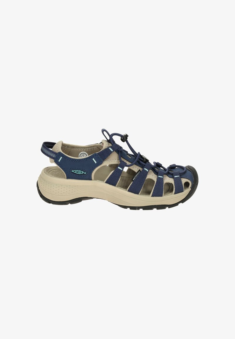 Navy blue sandal with an open design, featuring a cushioned footbed, adjustable bungee lacing, and rubber outsole for grip.