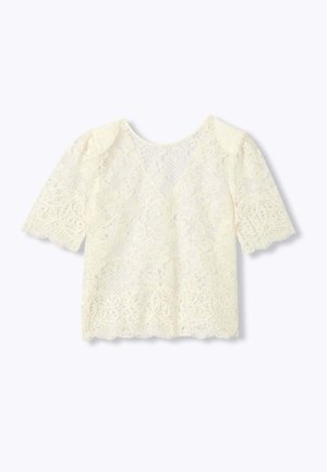 Blouse en dentelle crème à manches courtes, motifs floraux et géométriques, bords festonnés et col rond.