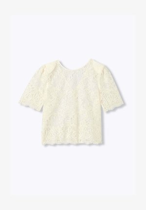 Blouse en dentelle crème à manches courtes, motifs floraux et géométriques, bords festonnés et col rond.