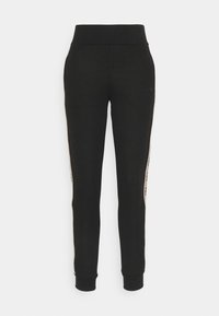 Pantalons de jogging noirs avec une taille ajustée, une jambe fuselée et des bandes latérales contrastantes comportant du texte. Tissu doux avec des poignets côtelés.