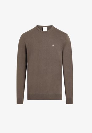 Maglione lungo marrone con maniche a sbuffo realizzato in tessuto morbido, dotato di scollo rotondo e di un piccolo logo CK bianco sul petto. Polsini e orlo a coste.