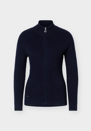 Laivastonsininen ribbineulottu neuletakki, jossa kokopitkä vetoketju edessä ja korkea kaulus, kapea leikkuinen malli hienovaraisilla teksturoiduilla kuvioilla.