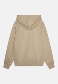 Beige hoodie med en texturerad finish, böjda sömmar och ribbade muddarna. Har en känguruficka och en löst sittande passform.