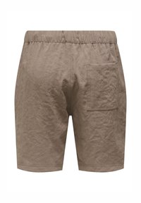 Braune Shorts aus einem strukturierten Stoff. Verfügt über einen elastischen Bund und eine seitliche Tasche. Einfaches Design, knielange Passform.