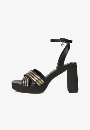 Black high-heeled platform sandals with a thick block heel, featuring textured gold horizontal bands across the front straps and adjustable ankle strap.