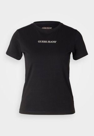 Schwarzes Baumwoll-T-Shirt mit taillierter Form, kurzen Ärmeln und rundem Ausschnitt. Mit weißem "GUESS JEANS"-Logo auf der Vorderseite.