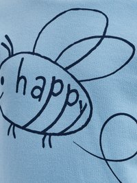 Ljusblått tyg med en svart, handritad bie-grafik och ordet "lycklig" i små bokstäver samt enkla linjeförskjutningar.