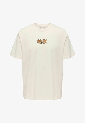 Camiseta de algodón color crema con mangas cortas y escote redondo. Presenta un gráfico del logo de AC/DC en naranja en el pecho. Ajuste simple y relajado.