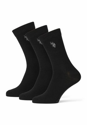 Schwarze Baumwollsocken, drei Paare, in mittlerer Wadenlänge mit gerippten Bündchen. Jedes Paar hat ein kleines, graues Logo. Glatte Textur, ohne Muster.