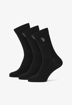 Schwarze Baumwollsocken, drei Paare, in mittlerer Wadenlänge mit gerippten Bündchen. Jedes Paar hat ein kleines, graues Logo. Glatte Textur, ohne Muster.