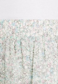 Tessuto a fantasia floreale con colori pastello e vita elasticizzata. Leggero e strutturato con una finitura morbida.