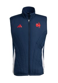 Granatowa ocieplana kamizelka z wysokim kołnierzem, zamek błyskawiczny z przodu, białe panele boczne, czerwone logo koguta i trzy czerwone paski na lewej piersi.