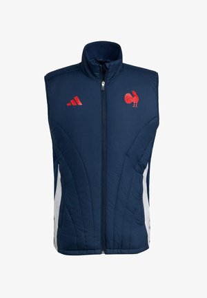 Chaleco acolchado de color azul marino con cuello alto, cierre frontal, paneles laterales blancos, logo de gallo rojo y tres rayas rojas en el lado izquierdo del pecho.