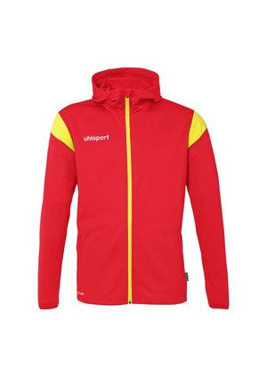 Rød og gul jakke med hætte, lavet af blødt stof. Har en fuld lynlås, to forlommer og logoet "uhlsport" trykt på brystet.