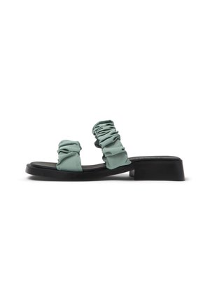 Mint green slide sandals with gathered fabric straps and a black flat sole. Features a simple design and smooth texture.