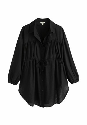 Schwarzes Hemd mit Knöpfen aus leichtem Stoff. Verfügt über einen Kragen, ein elastisches Band an der Taille und luftige Ärmel. Auffälliges Bindeband-Detail.