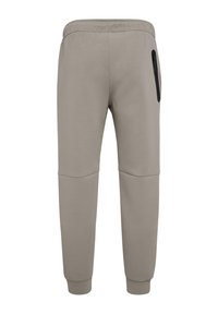 Joggebukser i bomuldsblanding i lys grå med indsnævrede ben, elastik i taljen og en sort lynlåslomme på højre side. Glat tekstur.