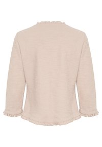 Hellrosa strukturierte Langarmbluse mit rüschigem Ausschnitt und Ärmeln, die einen lockeren Schnitt und einen abgerundeten Saum hat.