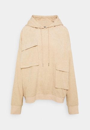 Beige kordfløjl hoodie med en tekstureret overflade, der har to forlommer, snørelukning i hætten og ribbede manchetter. Casual, løs pasform.
