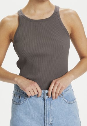 Gray ribbed tank top with a high neckline, fitted shape, and narrow straps, paired with light blue high-waisted denim shorts.
